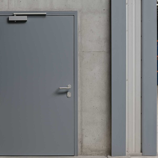 industrial-grade grey steel door installed in a commercial facility in Pakistan